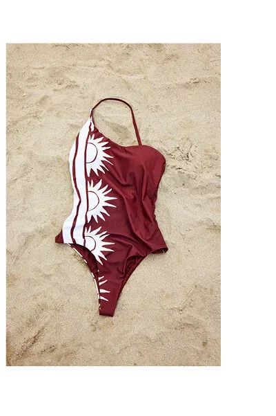 Asymmetric swimsuit with printed suns