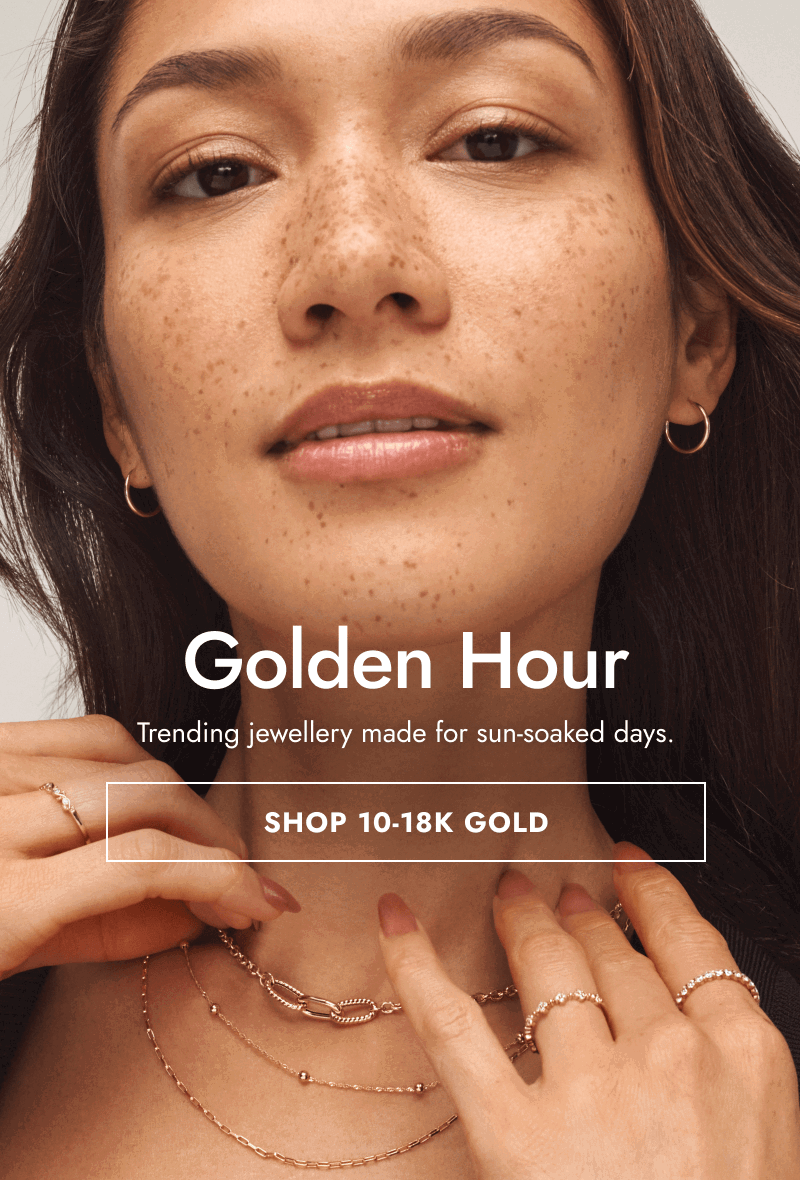 Woman wearing various fine yellow gold jewellery. Golden hour. Trending jewellery made for sun-soaked days. Click shop 10-18k gold.