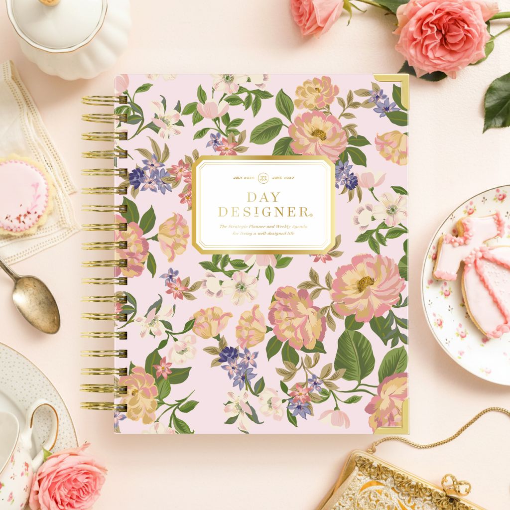 pretty pink floral day designer planner, peach background, cookies, tea cup and saucer, spoon, gold purse, pink flowers