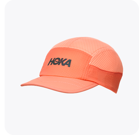 An image of a person from the back wearing the Hupana Sports Bra, a trail run hat, a close up of a person zipping up the Skyflow Jacket, and a close up of a person wearing the Elaro Biker shorts placing a phone into the side pocket.