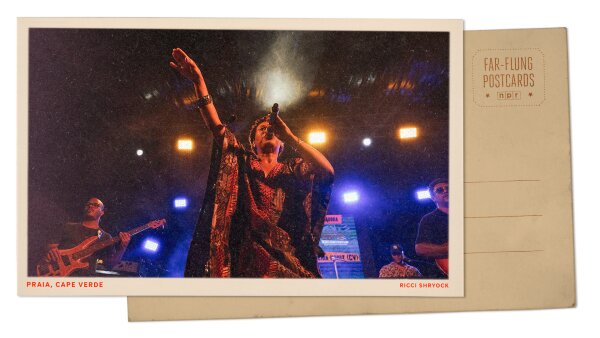A postcard with an image of a woman singing into a microphone and a band behind her.