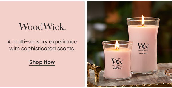 WoodWick logo and text describing a multi-sensory experience with sophisticated scents. Two lit candles and a Shop Now button.