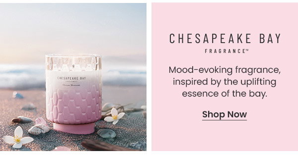 Text about Chesapeake Bay fragrance and a candle on the sand with small white flowers. Shop Now button visible.