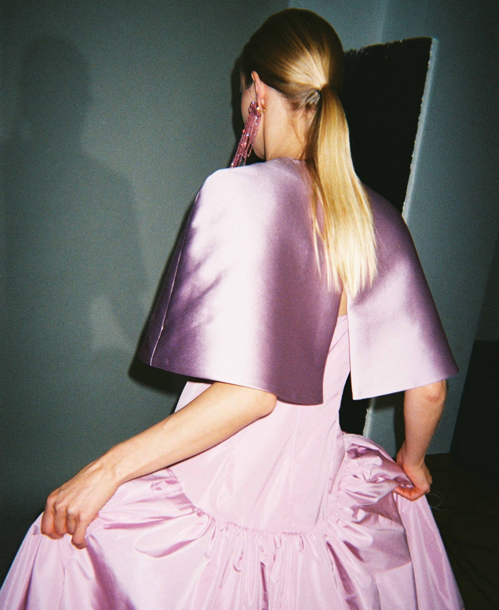 an image of a woman in a pink dress is posing for a picture