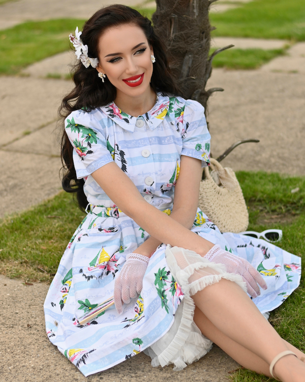 an image of a woman in a red dress posing for a picture