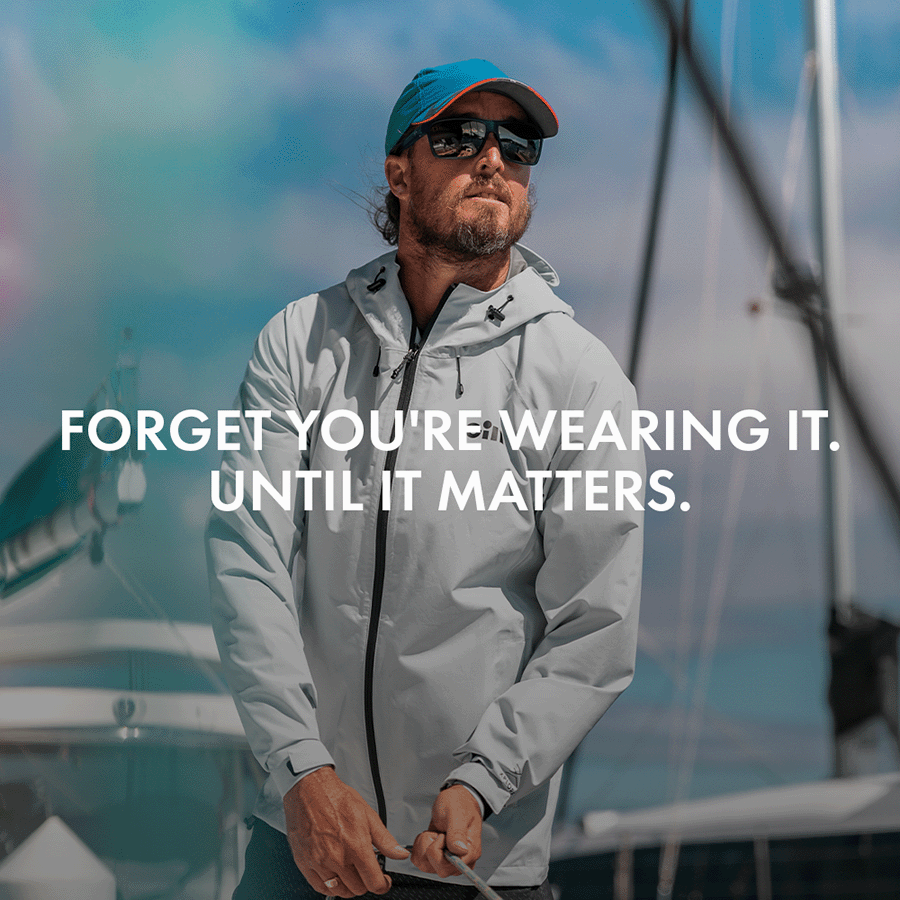 Man on a boat wearing a Light Grey Voyager Jacket 