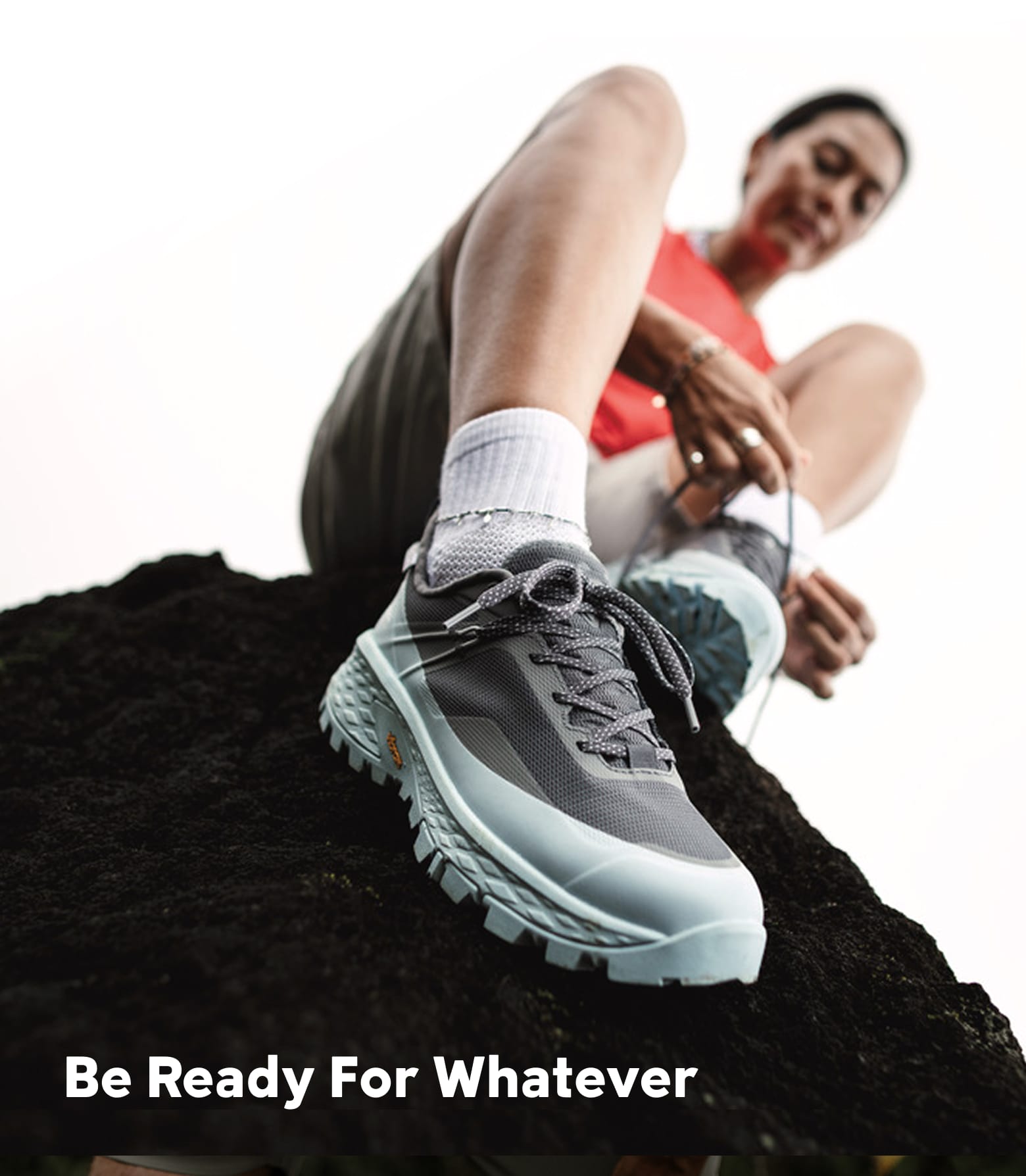 A woman lacing Columbia shoes on a lava rock. Be ready for whatever. 