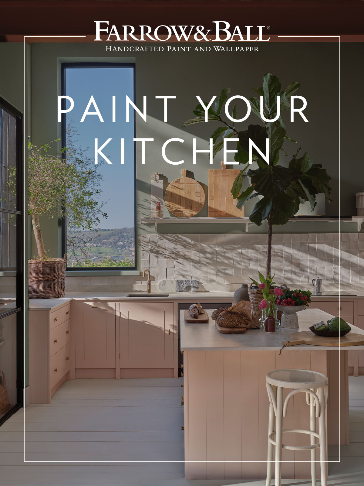 Sunlight falls through a large window, through which we get a glimpse of blue sky and the green fields beyond the house. Reflected in the verdant green walls and the lushness of the house plants, it’s a kitchen that draws on many elements of the natural world. The multi-textured stone tiles on the splashback are softened with the romantic pink cabinetry. Pull a stool up to the island and enjoy the view.