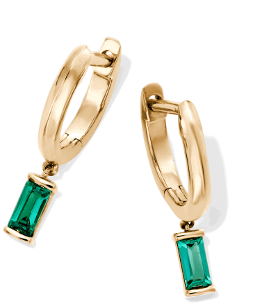 Yellow gold drop hoop earrings with emerald-cut green gemstone drops.