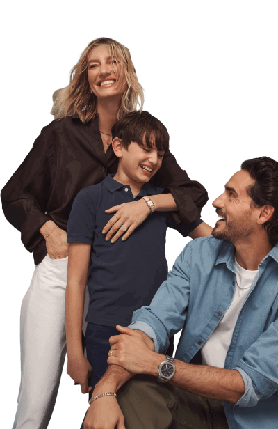 Smiling mom, dad, and son wearing watches, rings, bracelets, and necklaces.