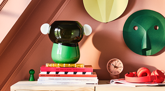Green vase sitting on shelf