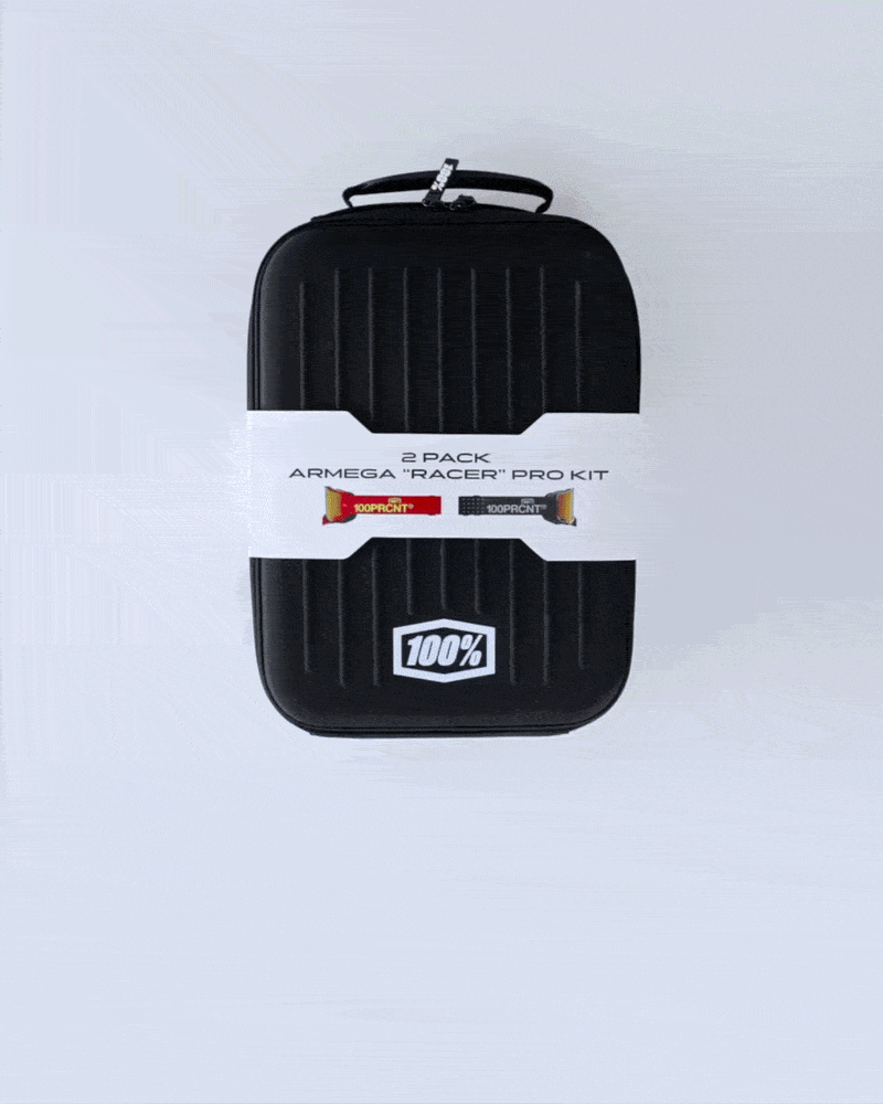 100% Armega "Racer" Pro Kit 2-Pack in a black hard-shell goggle case with product band.