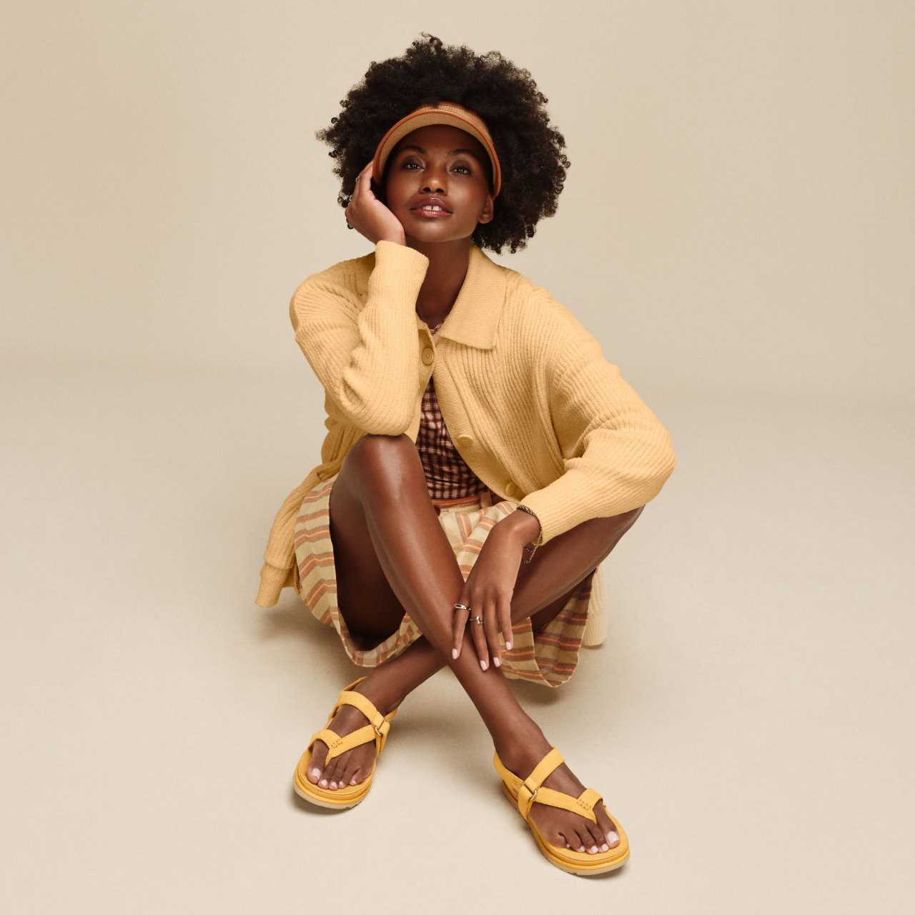 A model wearing the Goldengaze Sandal in yellow.