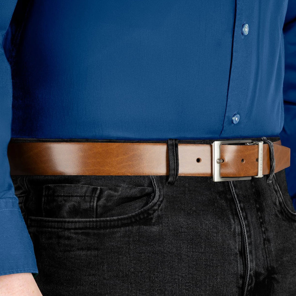 Close up of a man wearing a heritage reversible leather belt in black/tan