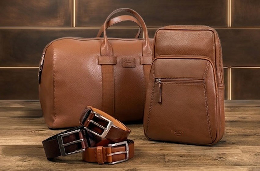 Men's leather bags and belts in various colours and styles on the wooden and tiled background