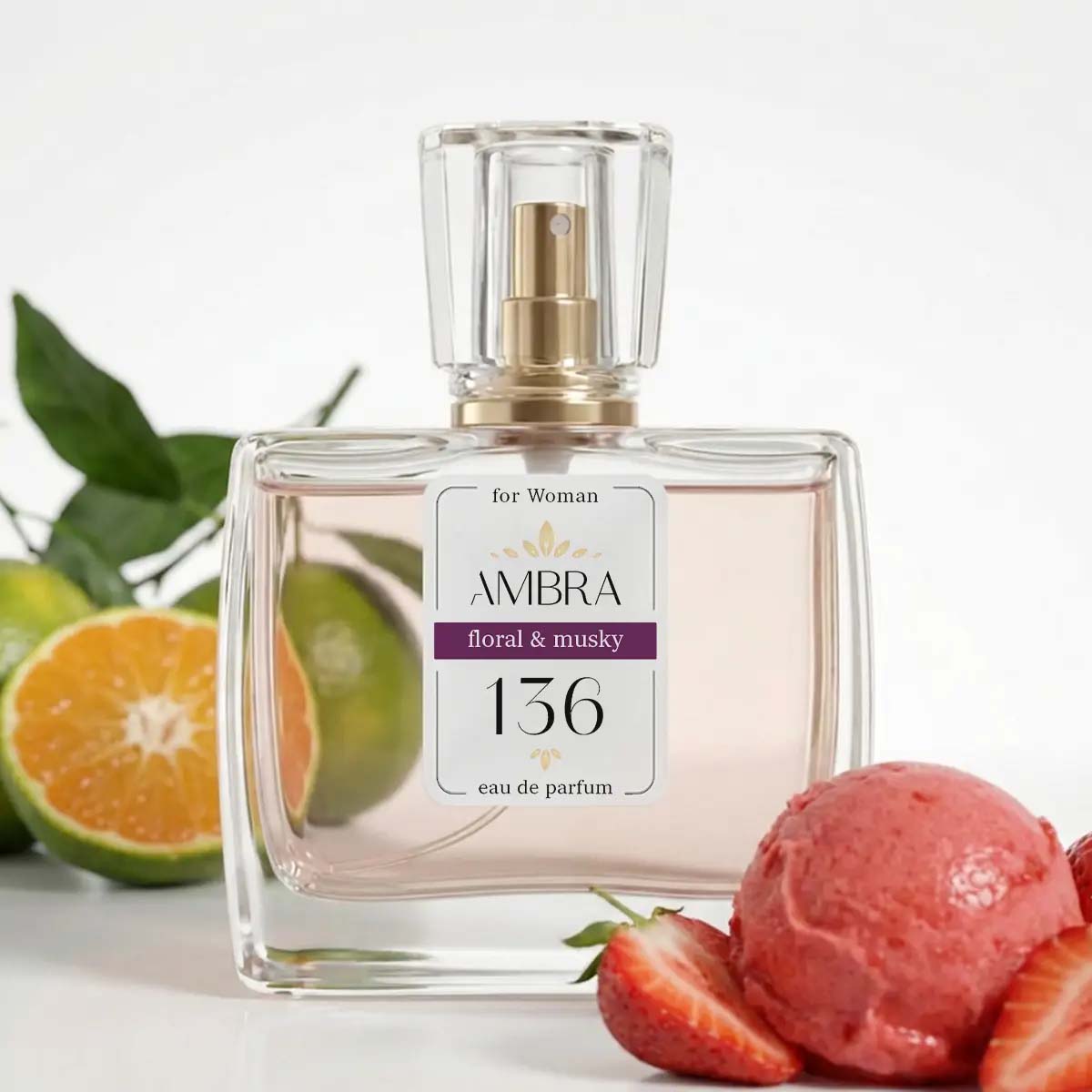 Clear glass bottle of Ambra 136 floral & musky eau de parfum for women beside sliced citrus and strawberry sorbet