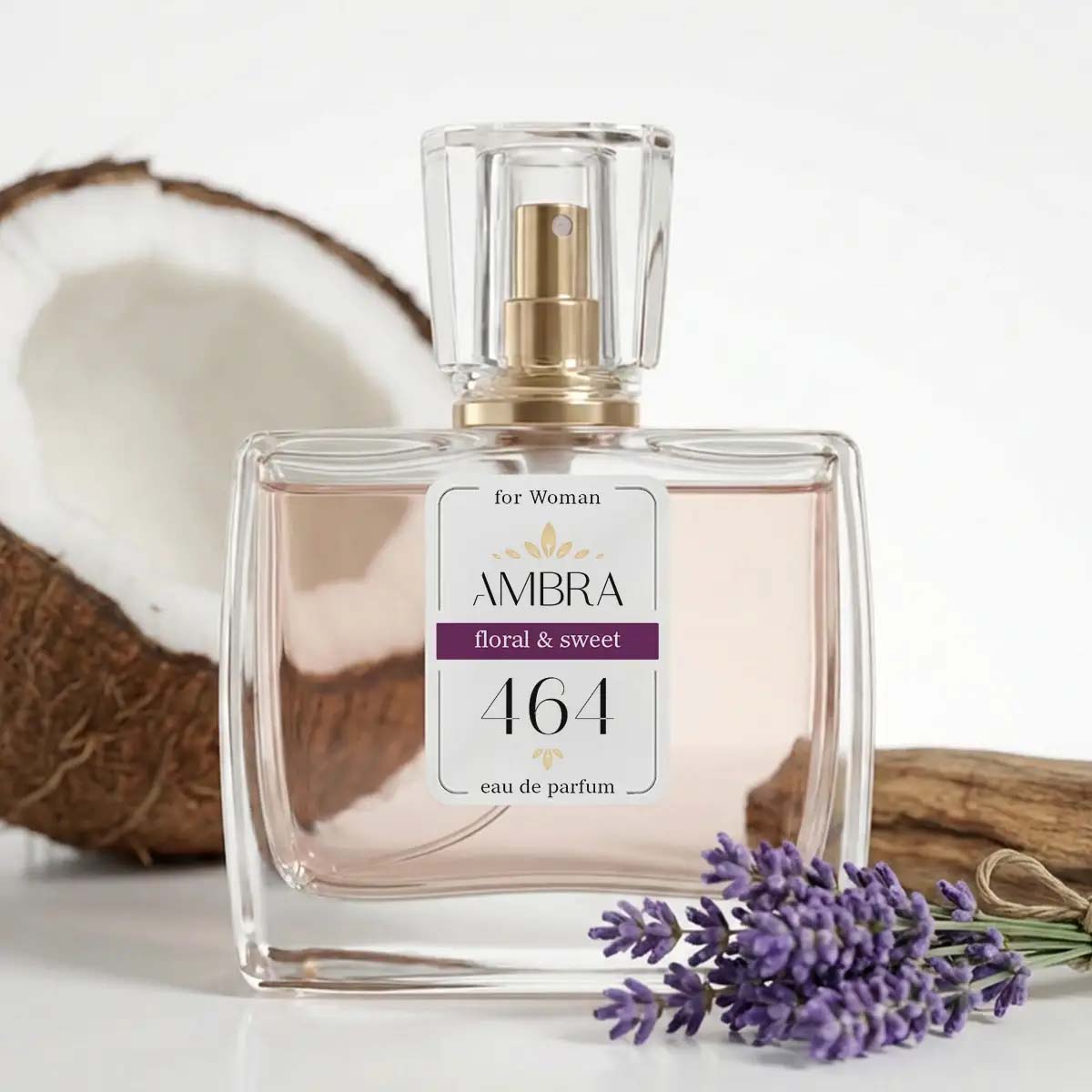 Glass perfume bottle labelled 'AMBRA 464 floral & sweet' beside lavender sprig and halved coconut, eau de parfum for women