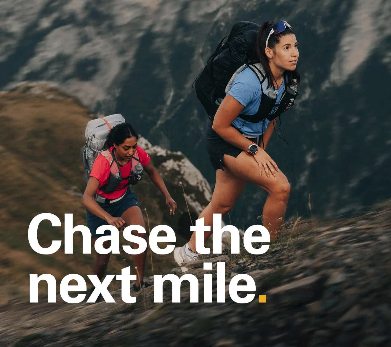 'Chase the next tile' Text of the image of 2 women trail running un in the mountains.