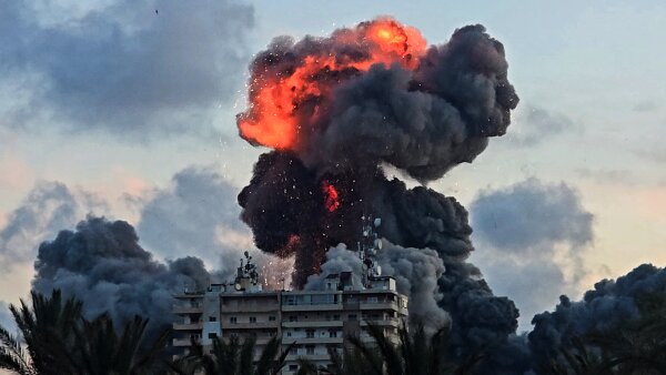 A fireball and smoke erupt from a building following an Israeli strike in Tyre, southern Lebanon.