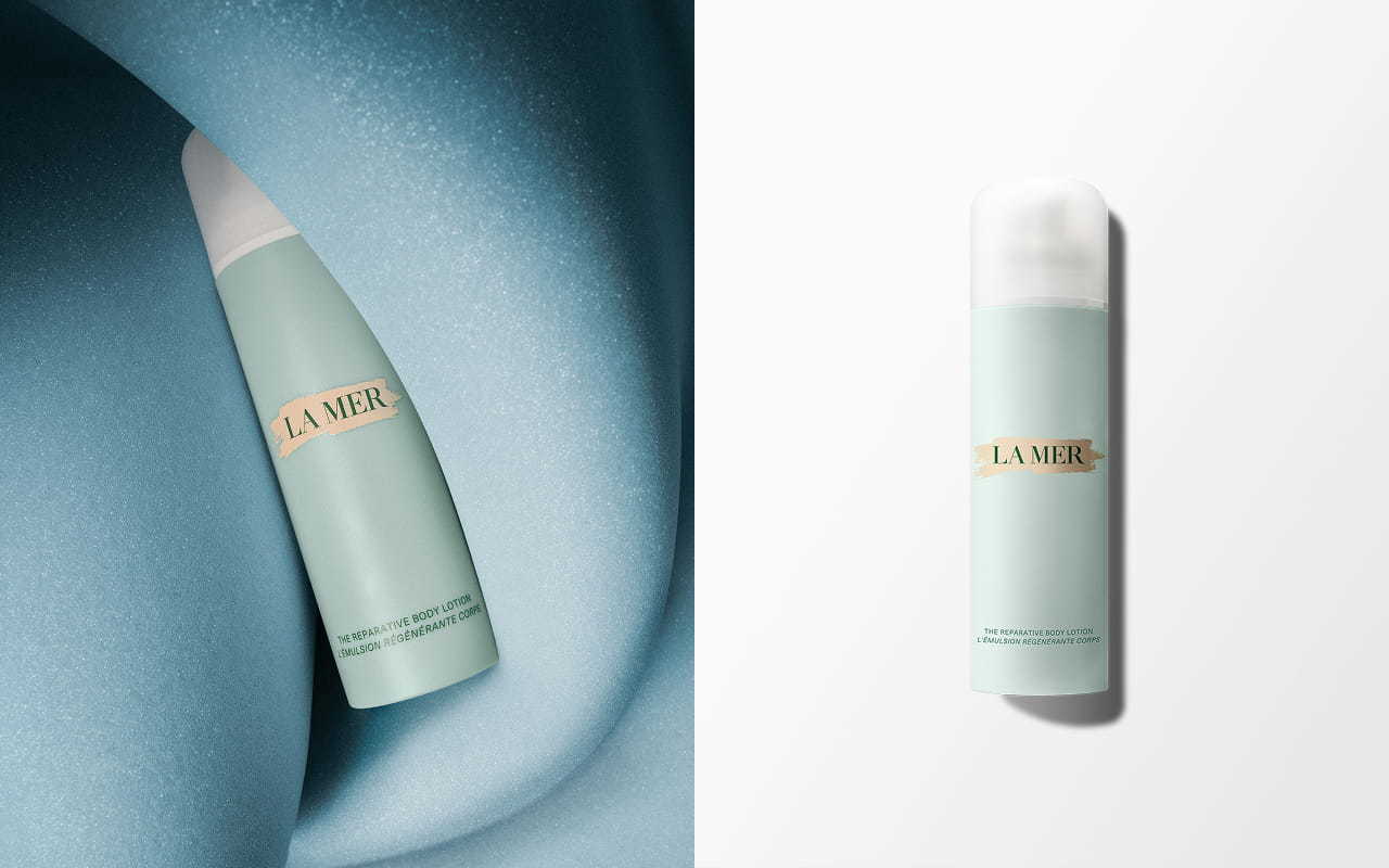 In the left section, bottle of The Reparative Body Lotion partly wrapped with a textured, swirling blue fabric. In the right section, the same bottle on a light grey background.