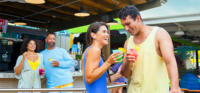 A group of friends enjoying frozen drinks during Adventure Island's Happy Hour