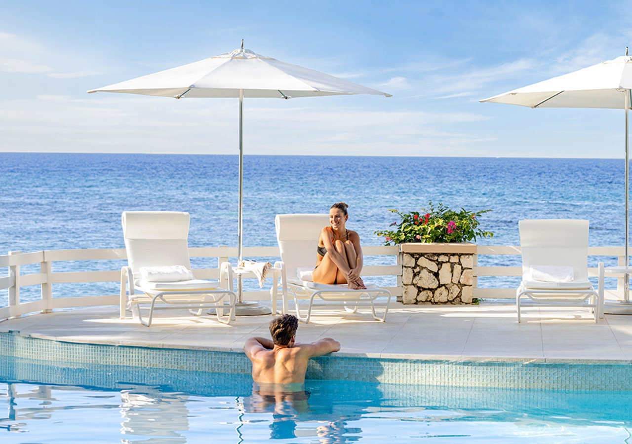 a man and woman sitting in a pool