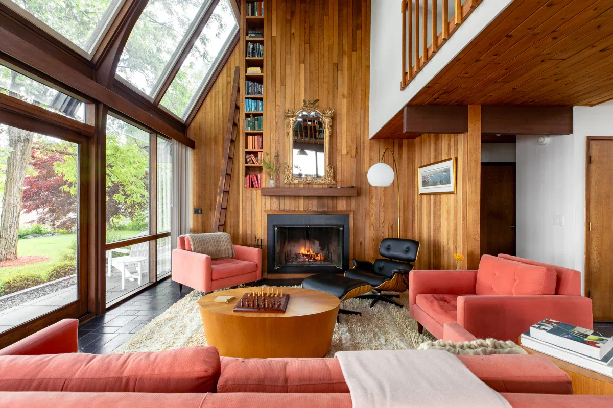 A large open room with plenty of places to sit near a fireplace.