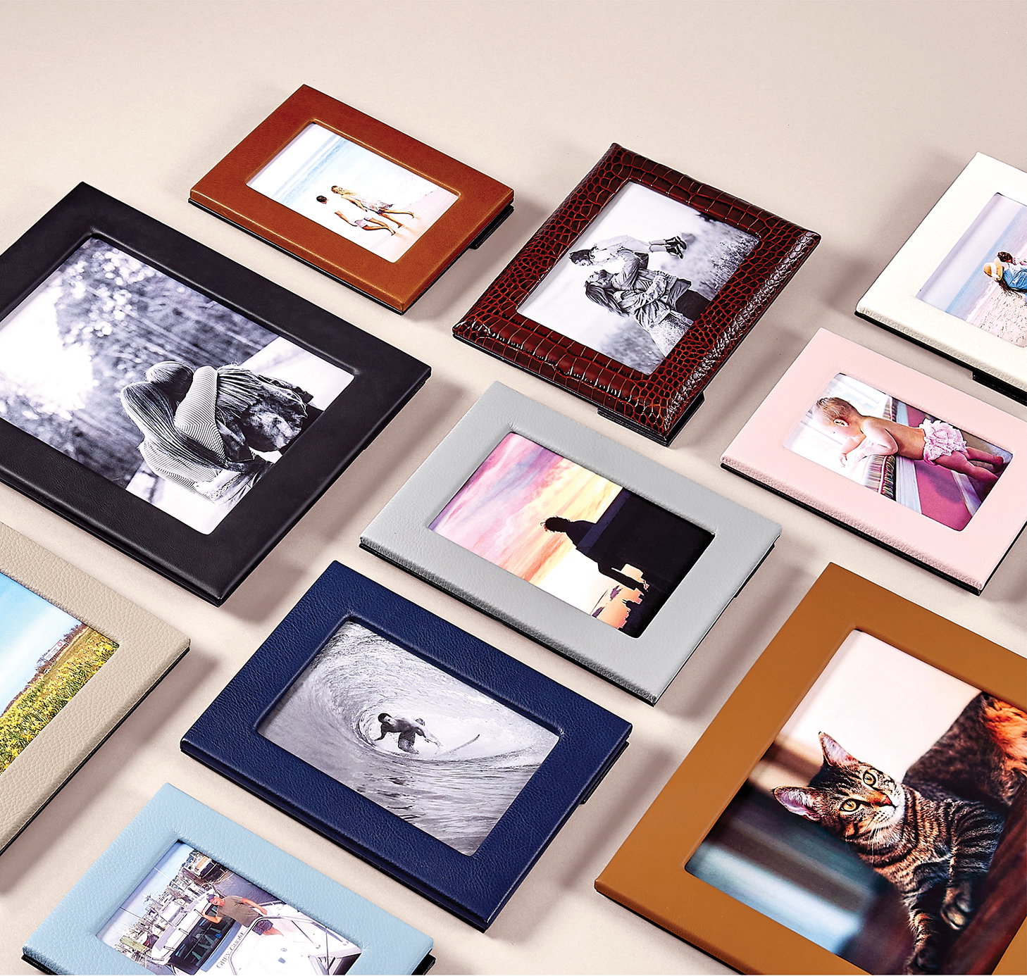 An assortment of leather picture frames in various colors and sizes.