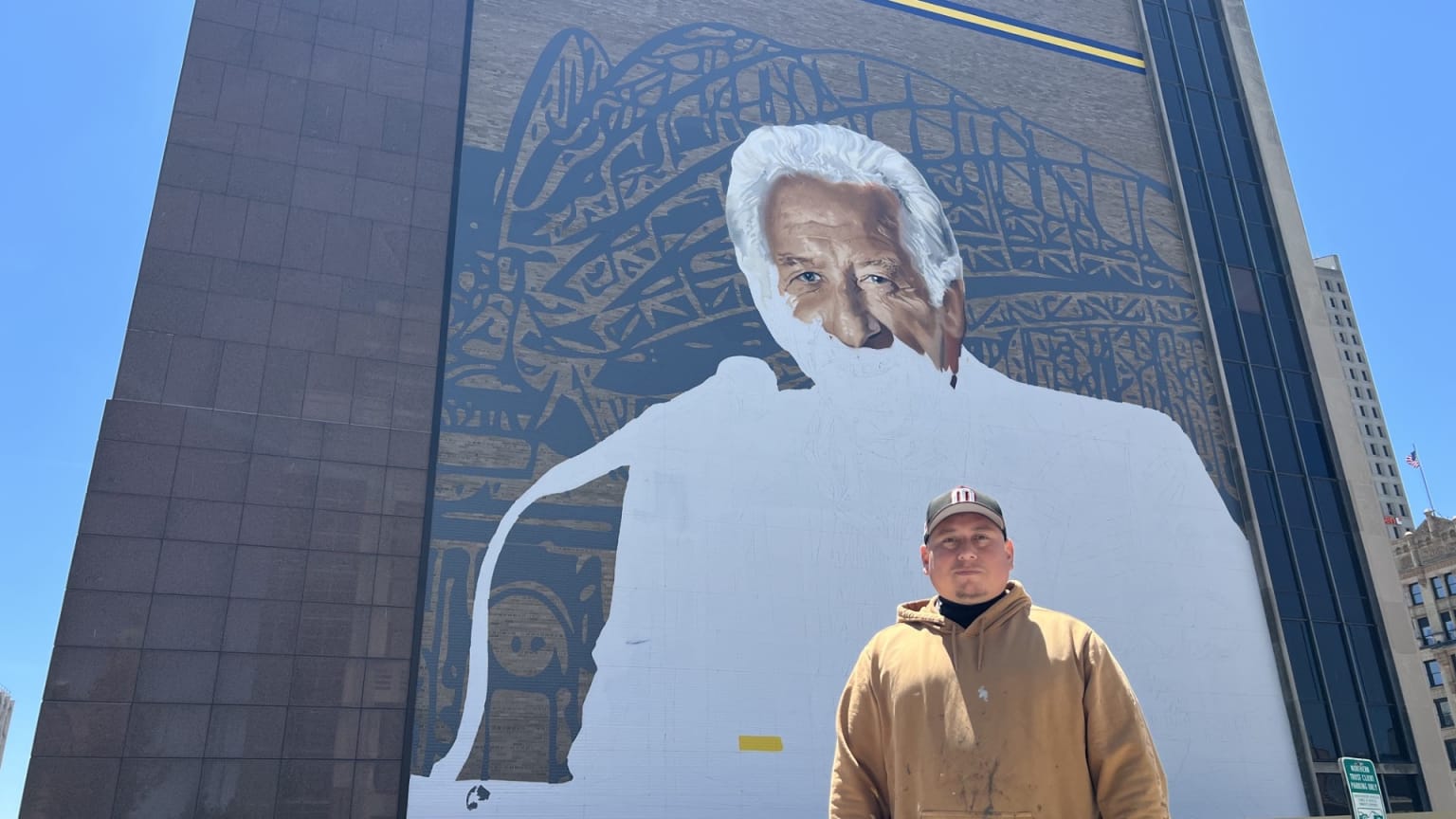 Artist Mauricio Ramirez painting Bob Uecker mural in Milwaukee