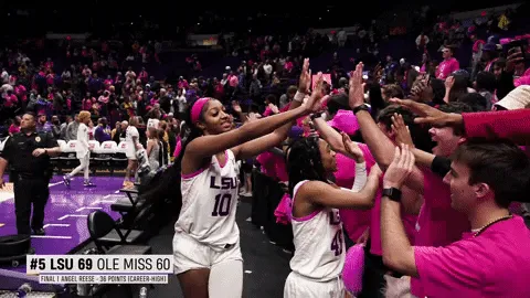 Angel Reese high fiving the audience.