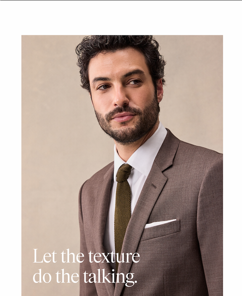 Man in a brown suit, white dress shirt, and olive knit tie with a white pocket square, looking off-camera against a neutral background. "Let the texture do the talking."