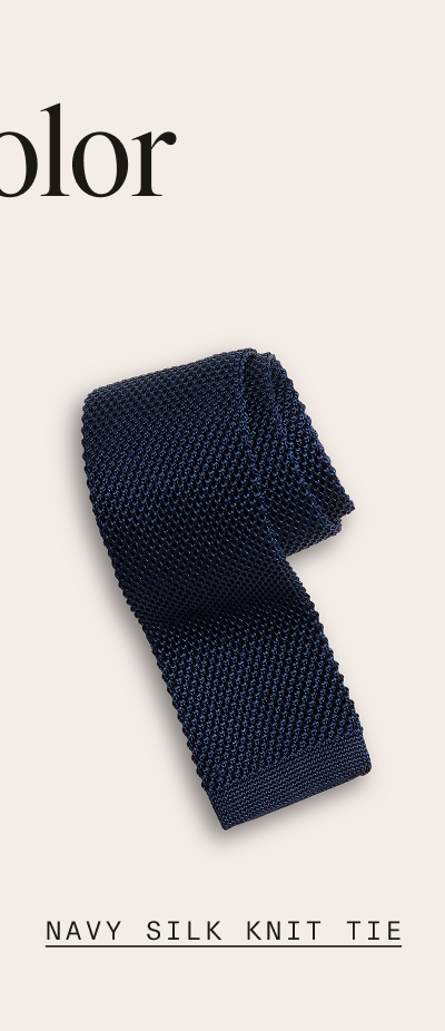  Flat lay of a folded navy knit tie with a square bottom end on a light background. "NAVY SILK KNIT TIE"
