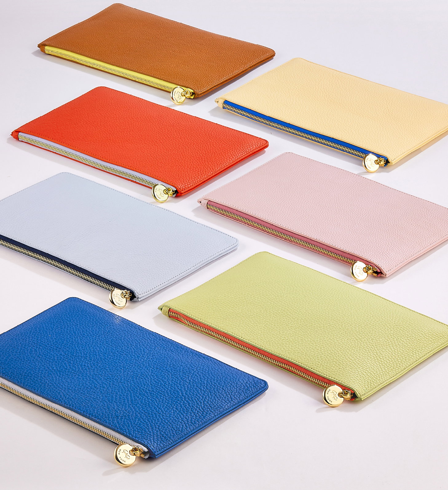 The Birdie Pouch in Tan, Chiffon, Coral, Pink, Periwinkle, Celadon, and Cobalt.