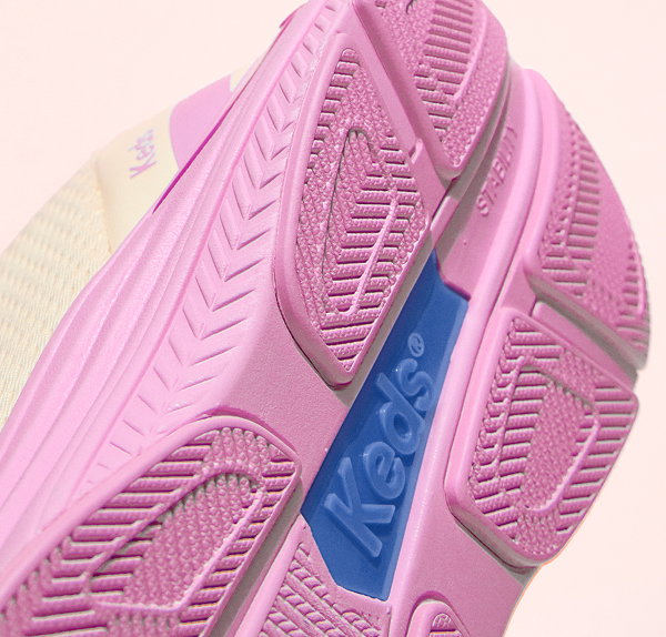 A closeup on the outsole of the BlissMove Mesh/Leather Lace-Up in egret/lilac/dark violet showcasing the sneaker’s high-traction grooves and Keds logo.