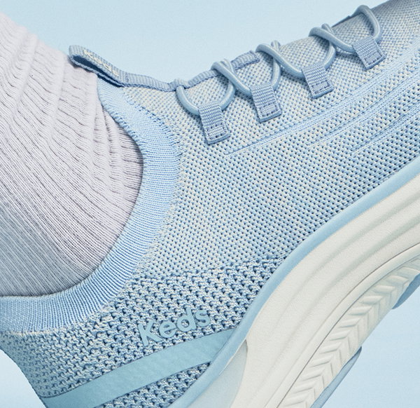A closeup of the BlissMove Marled Knit Slip-On in light blue showcasing the sneaker’s stretch knit upper and stretch fixed laces.