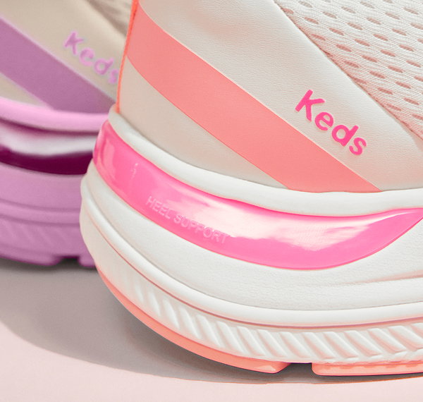 A closeup on the heels of two BlissMove Lace-Ups showcasing the heel support and Keds logo on the side.
