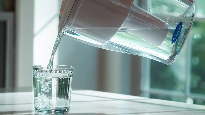 Pouring fresh filtered water from a Crystal Quest pitcher