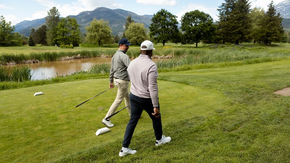 image: golfers walking the course