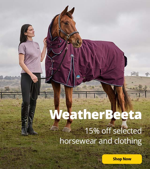 Woman wearing Weatherbeeta, holding a horse and its reins
