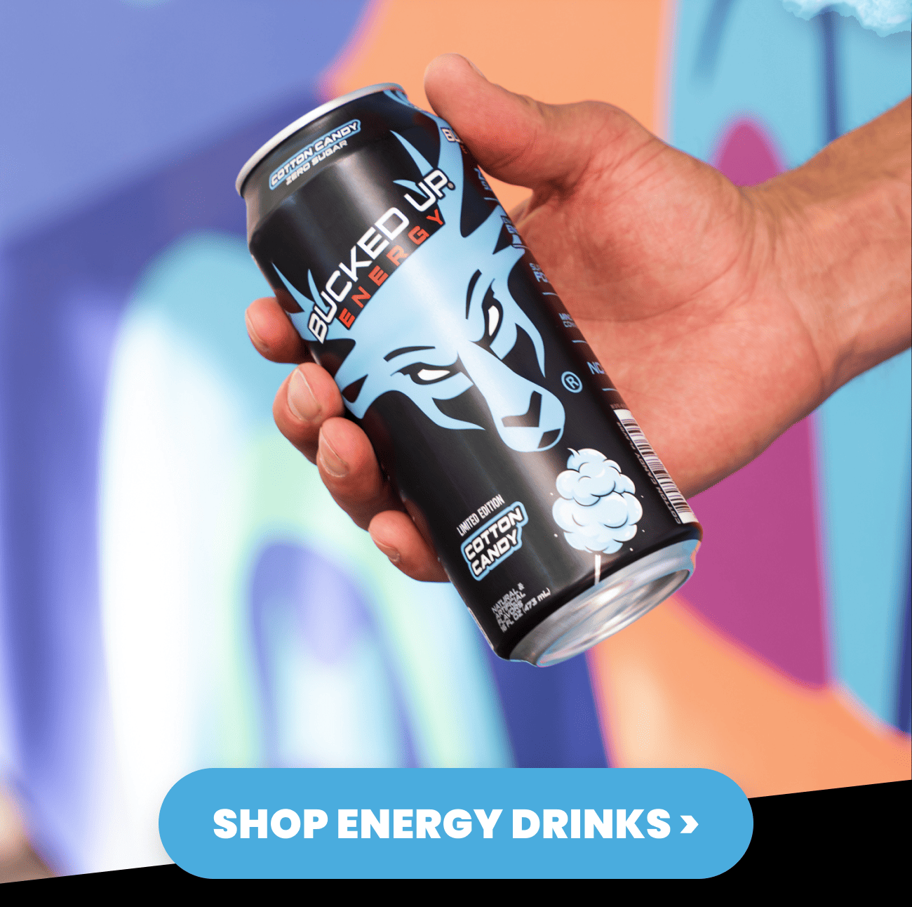 Hand holding Bucked Up Energy limited edition Cotton Candy zero sugar can, shop energy drinks