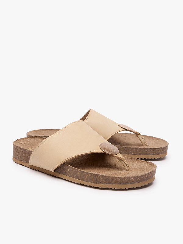 Beige leather sandals with cork soles and wide straps on a white background.