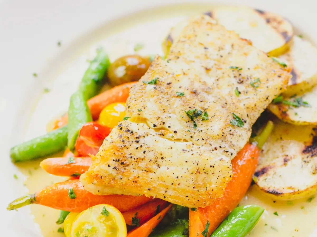 A colorful plating of halibut, baby carrots and snow peas at PlumpJack Cafe, the restaurant in PlumpJack Squaw Valley Inn in Squaw Valley, Calif., on Lake Tahoe's North Shore. The resort takes its name from a Shakespeare character.