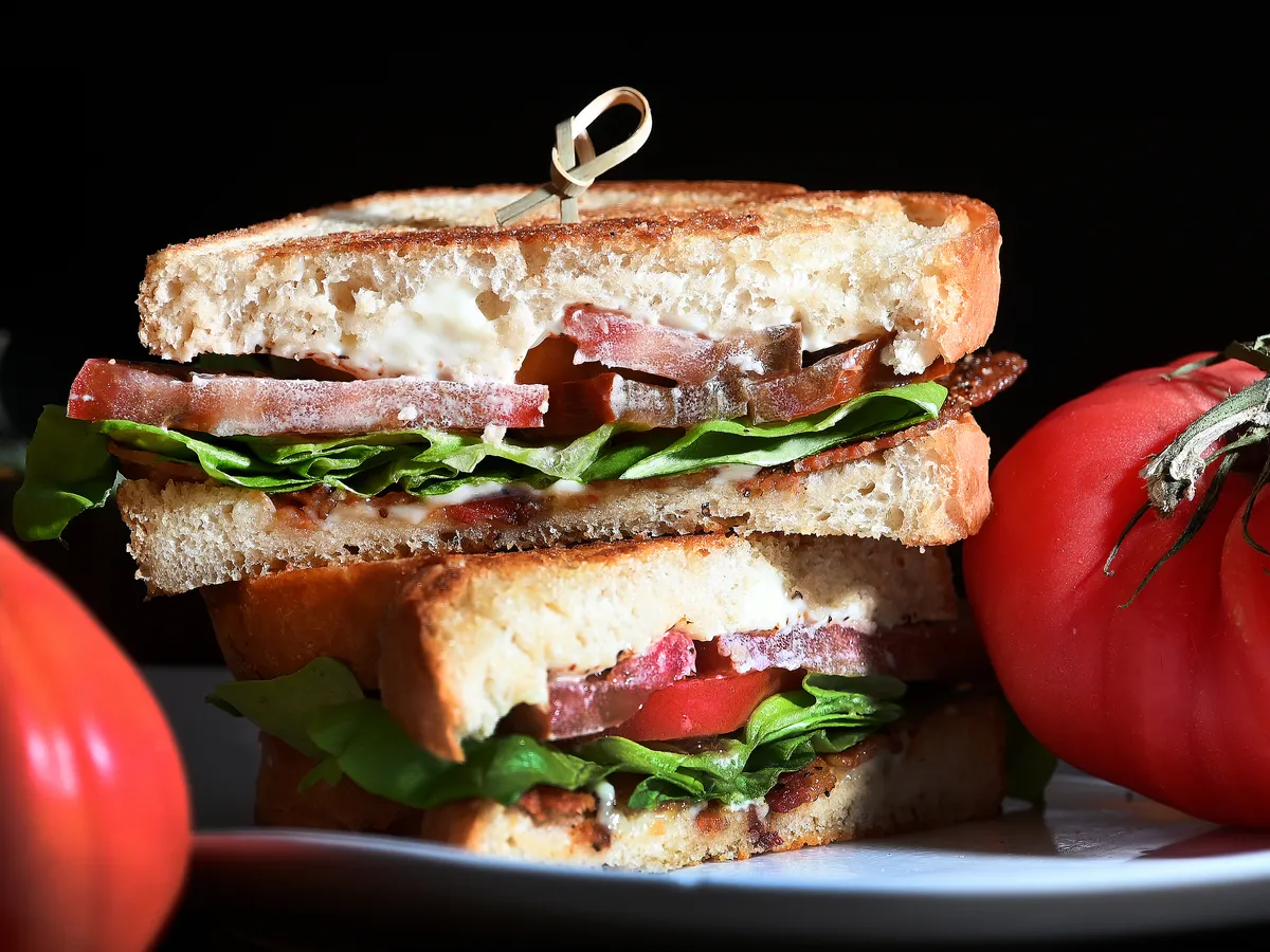 Chirs Walker, left, and Molly Cashman talk about the Blue Moon's Tomato Sandwich.
