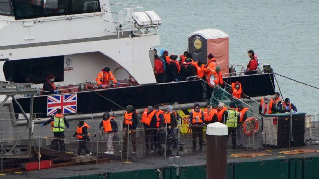 A group of people thought to be migrants, wearing bright orange life-vests, are brought in to the Border Force compound in Dover, Kent, from a Border Force vessel following a small boat incident in the Channel.