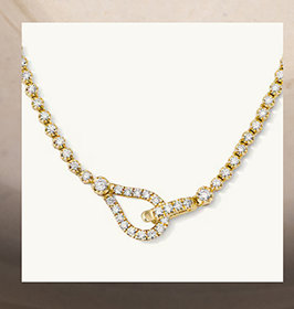 A gold diamond tennis necklace with a loop and buckle clasp.
