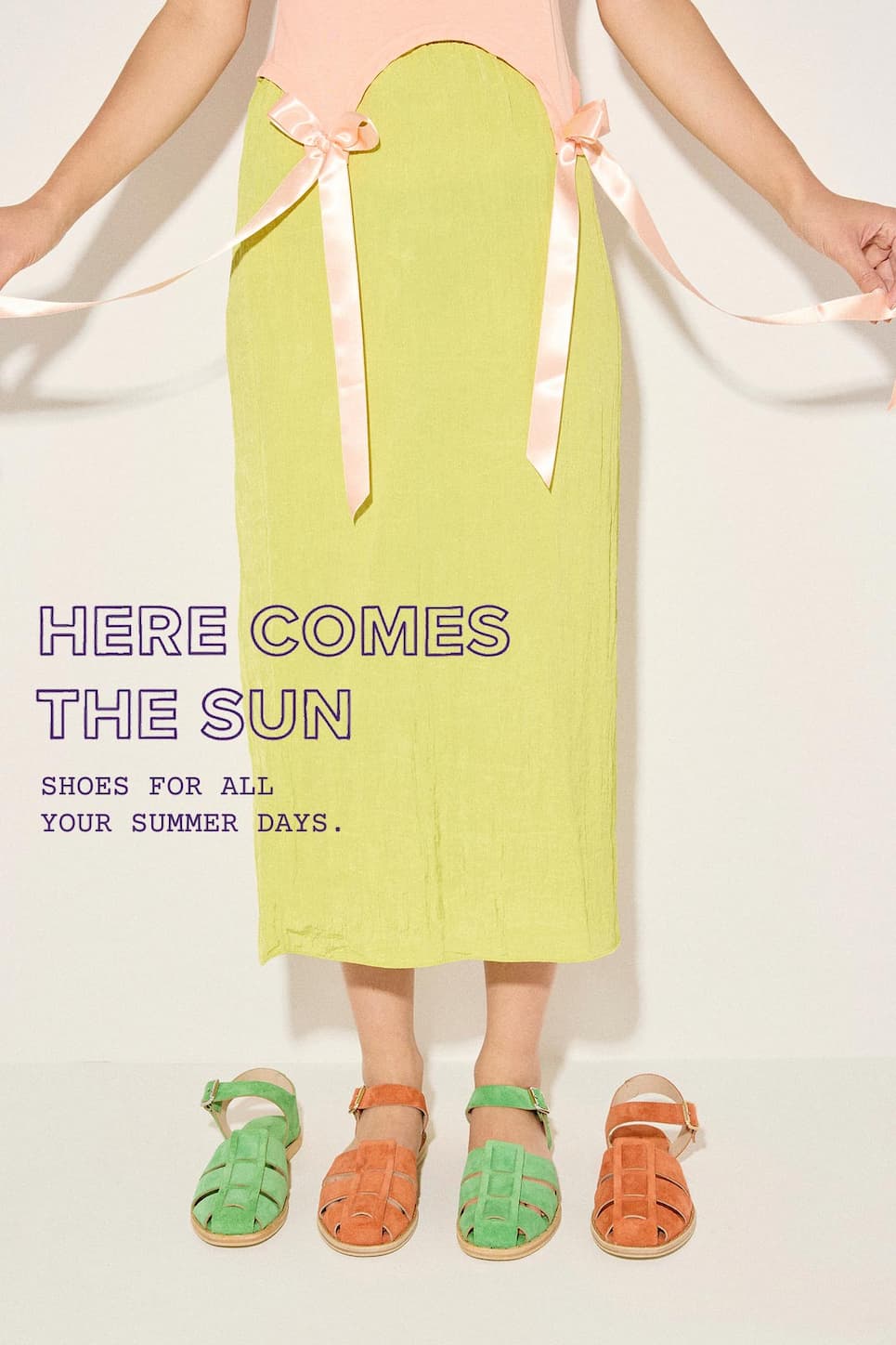 Line up of alternating SERA fisherman sandals in Kelly Green and Cantalope pictured on floor, model is wearing two different colors styled with yellow skirt