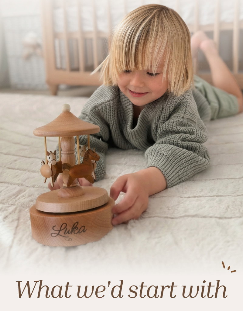 Young child playing with a wooden carousel on the floor beside large brown text reading What We'd Start With.