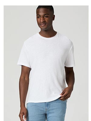 A man wearing a white linen blend t-shirt with raw hem collar detail.
