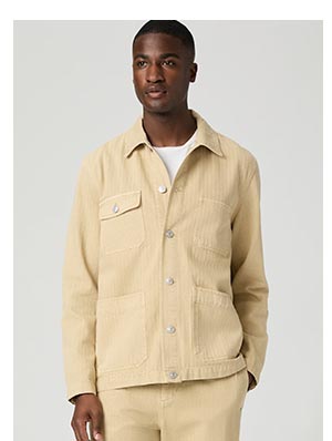 A man wearing a buttery tan denim jacket with tonal stripe detail.