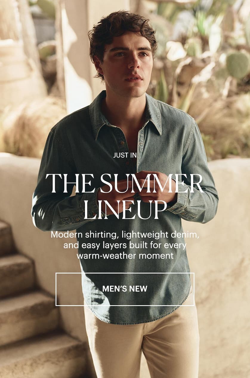 Just In - The Summer Lineup: Modern shirting, lightweight denim, and easy layers built for every warm-weather moment. Featuring a man wearing a blue denim long sleeve popover shirt and light cream jeans.